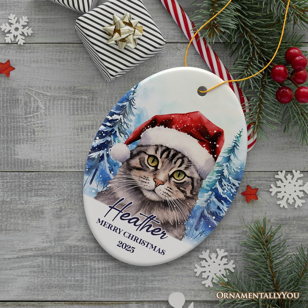 Tabby Cat with Santa Hat Personalized Ornament, Winter Forest Christmas Gift With Custom Name and Date Ceramic Ornament OrnamentallyYou Oval