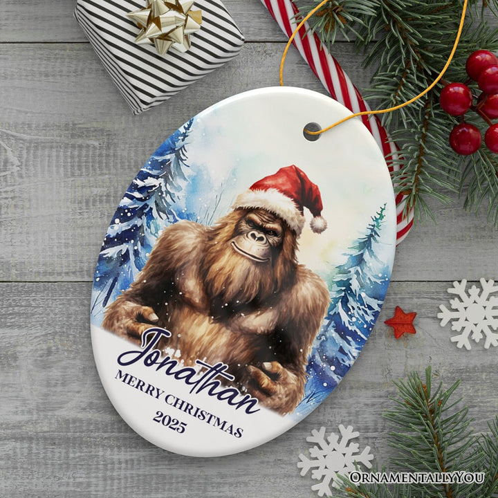 Bigfoot with Santa Hat Personalized Ornament, Winter Forest Christmas Gift With Custom Name and Date Ceramic Ornament OrnamentallyYou Oval 