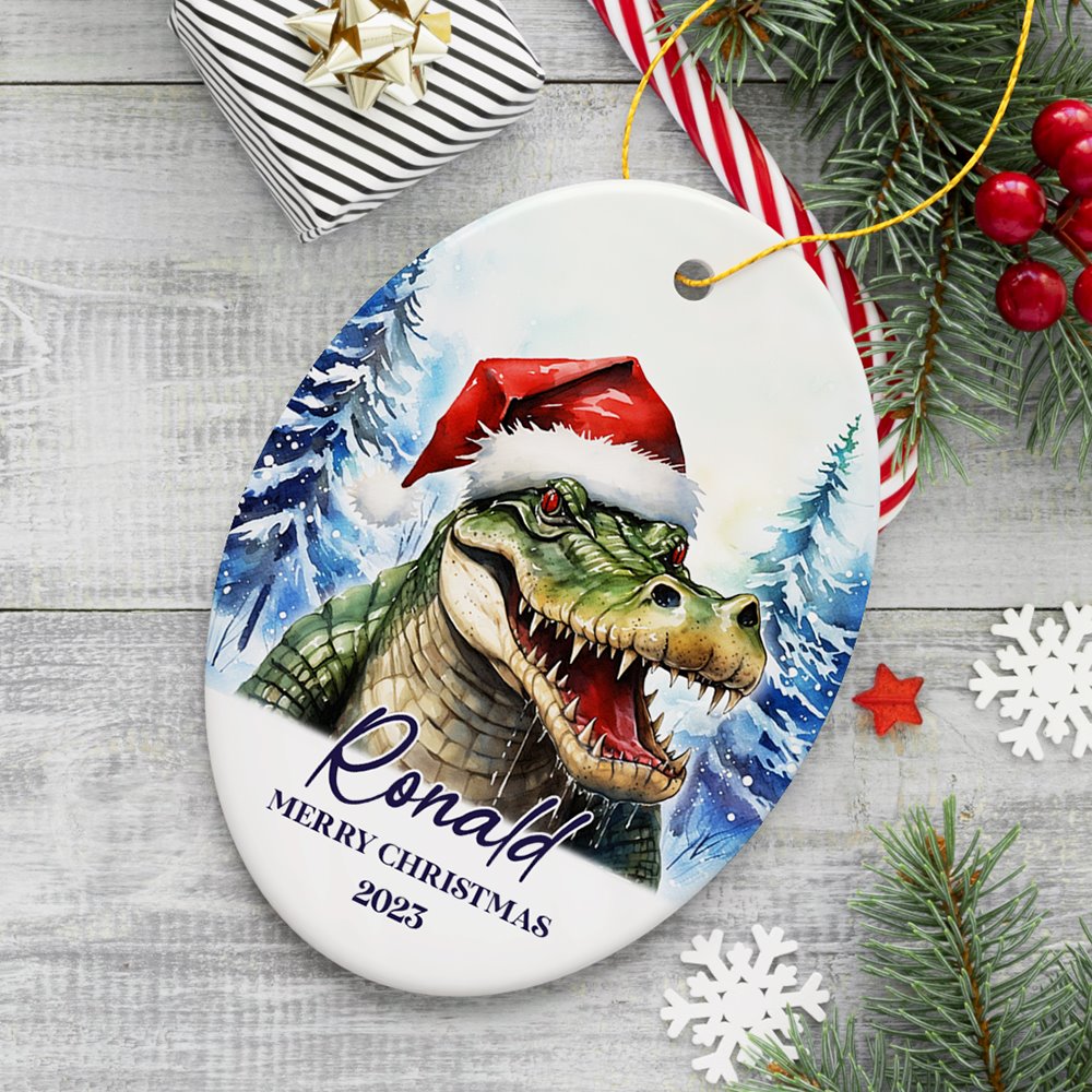 Alligator with Santa Hat Personalized Ornament, Winter Forest Christmas Gift With Custom Name and Date Ceramic Ornament OrnamentallyYou Oval 