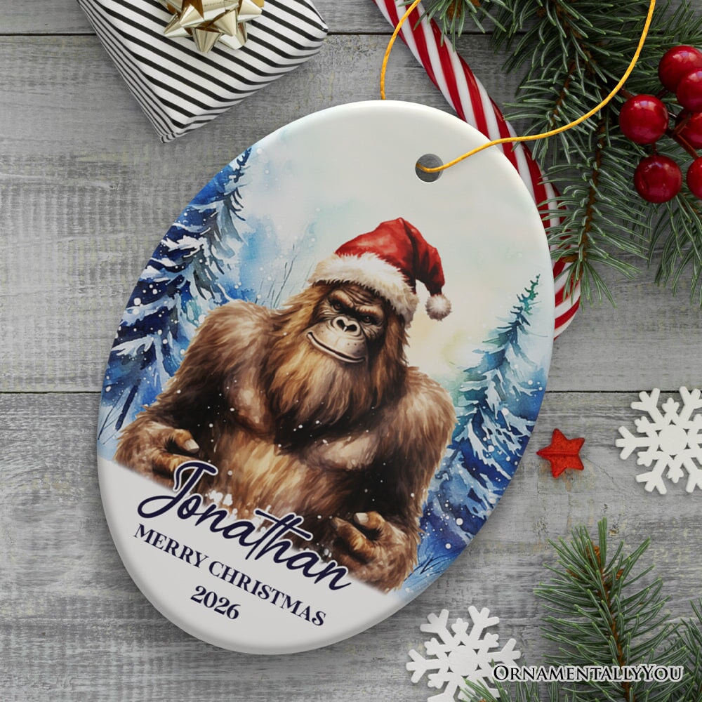 Bigfoot with Santa Hat Personalized Ornament, Winter Forest Christmas Gift With Custom Name and Date Ceramic Ornament OrnamentallyYou Oval 