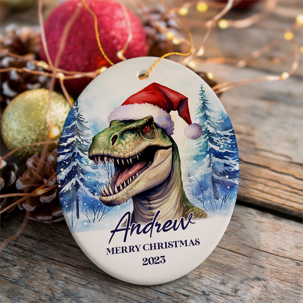 Dinosaur with Santa Hat Personalized Ornament, Winter Forest Christmas Gift With Custom Name and Date Ceramic Ornament OrnamentallyYou Oval 