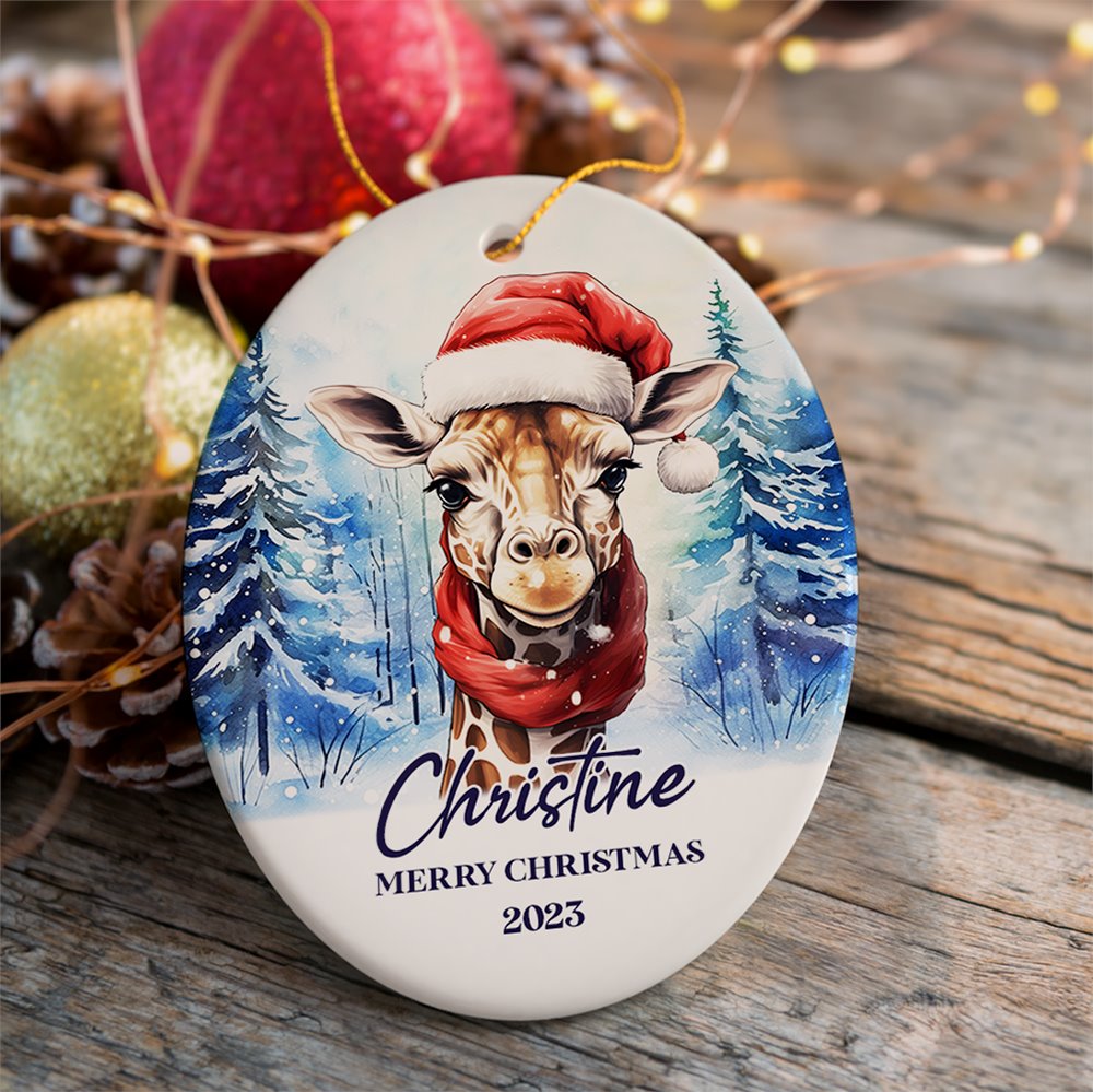 Giraffe with Santa Hat Personalized Ornament, Winter Forest Christmas Gift With Custom Name and Date Ceramic Ornament OrnamentallyYou Oval 
