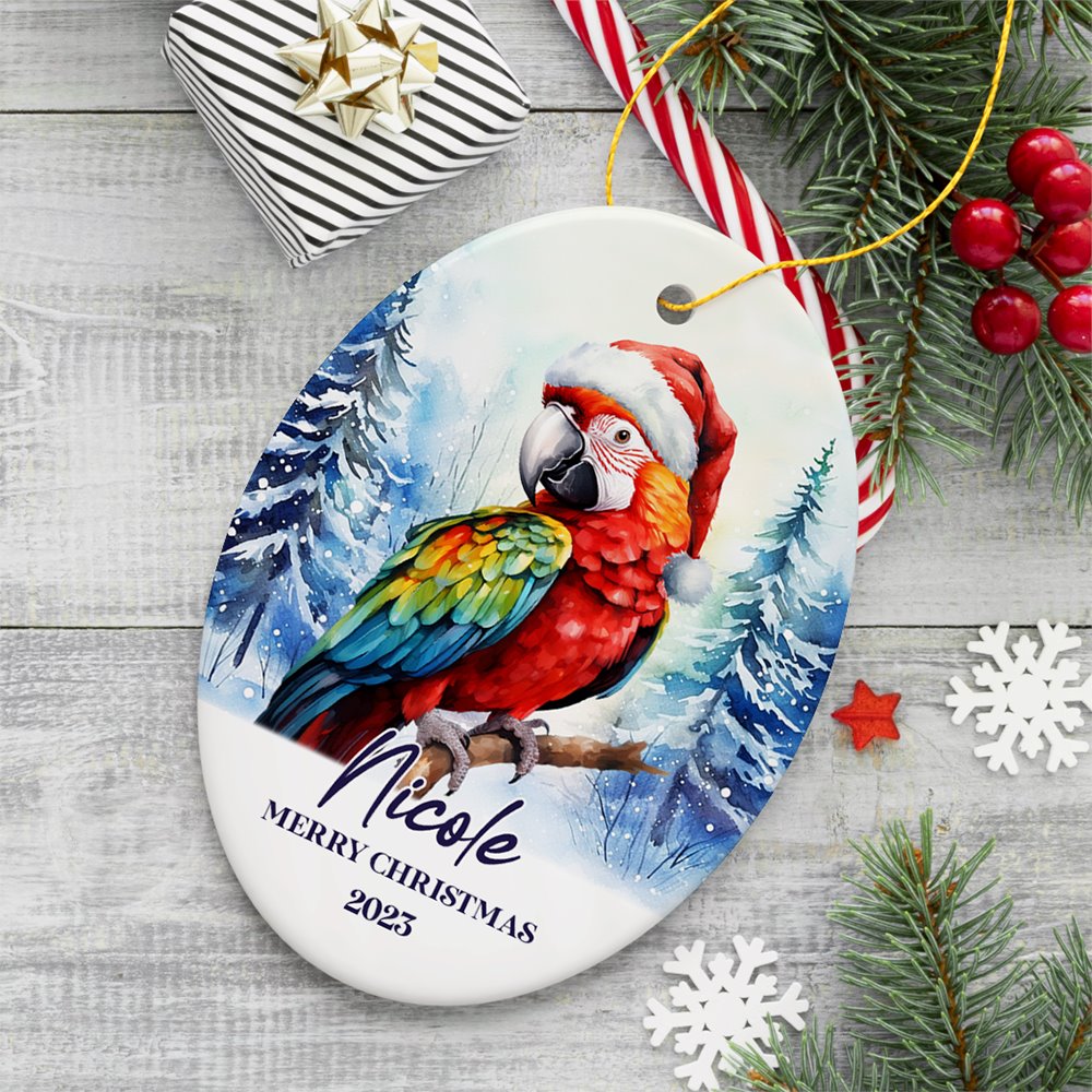 Macaw Parrot with Santa Hat Personalized Ornament, Winter Forest Christmas Gift With Custom Name and Date Ceramic Ornament OrnamentallyYou Oval 