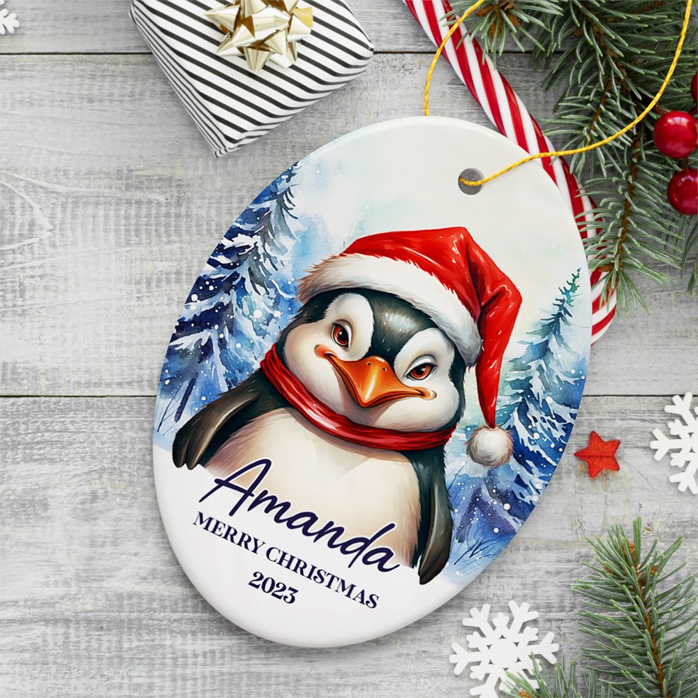 Penguin with Santa Hat Personalized Ornament, Winter Forest Christmas Gift With Custom Name and Date Ceramic Ornament OrnamentallyYou Oval 