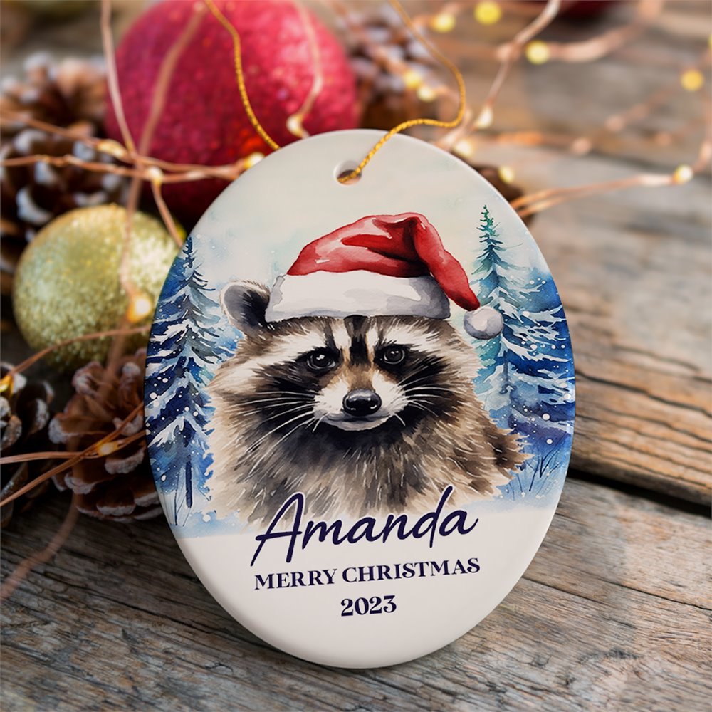 Raccoon with Santa Hat Personalized Ornament, Winter Forest Christmas Gift With Custom Name and Date Ceramic Ornament OrnamentallyYou Oval 