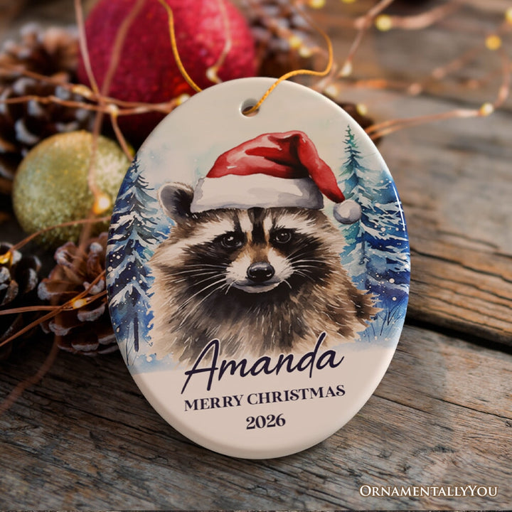 Raccoon with Santa Hat Personalized Ornament, Winter Forest Christmas Gift With Custom Name and Date Ceramic Ornament OrnamentallyYou Oval 