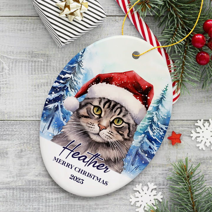 Tabby Cat with Santa Hat Personalized Ornament, Winter Forest Christmas Gift With Custom Name and Date Ceramic Ornament OrnamentallyYou Oval 