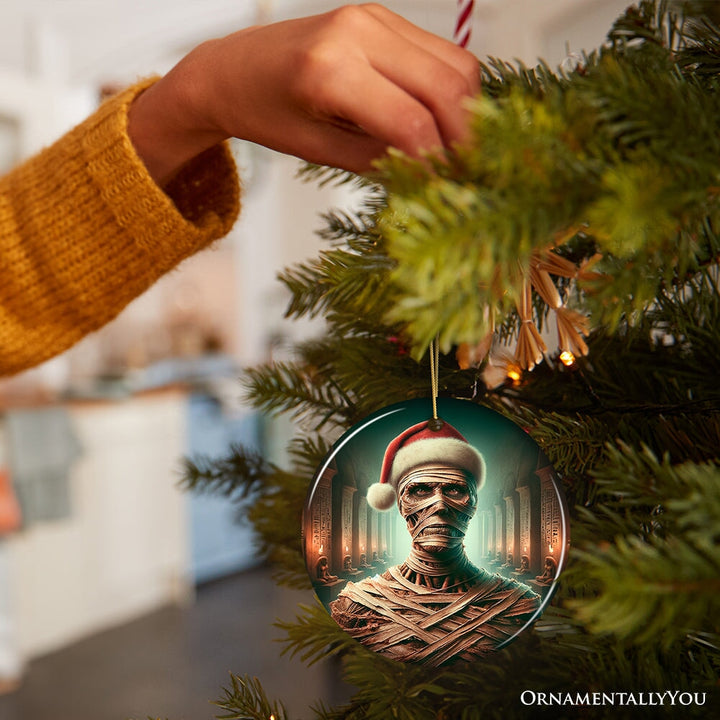 Ancient Mummy with Santa Hat Ornament, Enigmatic Holiday Gift for Horror Enthusiasts Ceramic Ornament OrnamentallyYou 