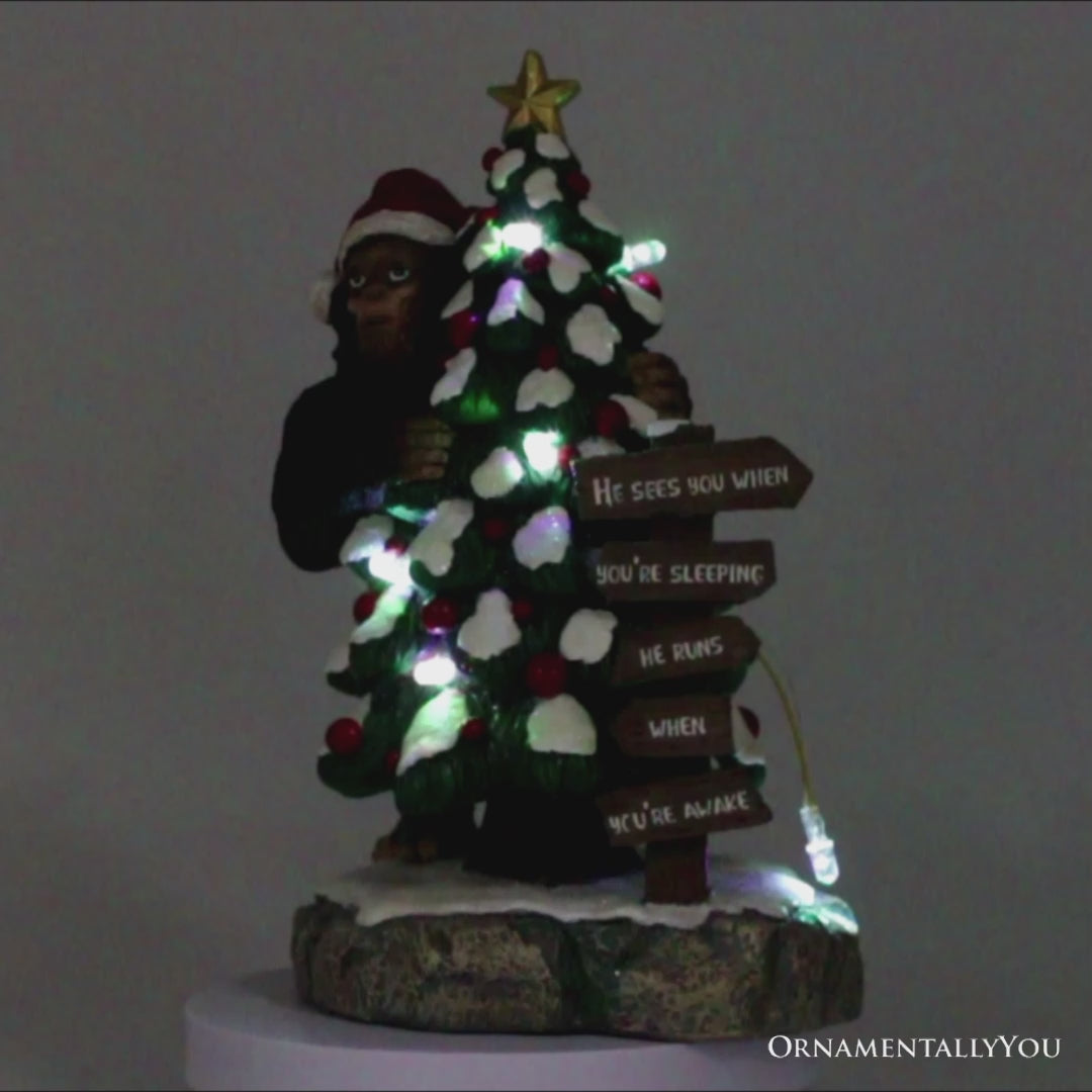 Whimsical Bigfoot Behind Christmas Tree Figurine, 7.5" Funny Holiday Yeti LED Statue, He Sees You When You're Sleeping